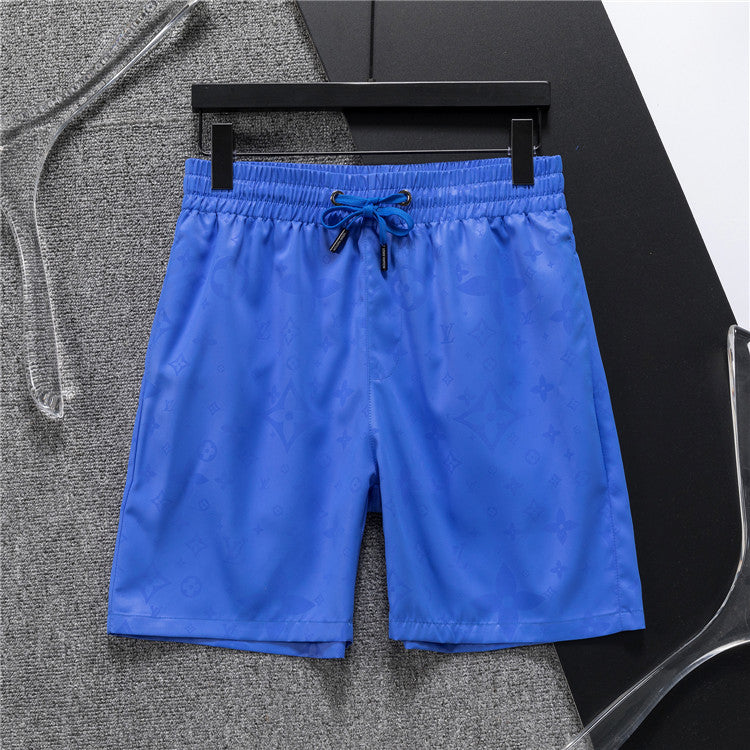 Blue shorts on a hanger against a gray background